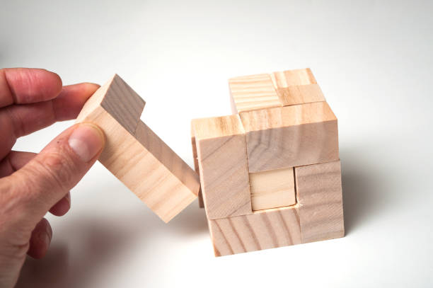 istock man hand with wooden puzzle  on white background 1083044048