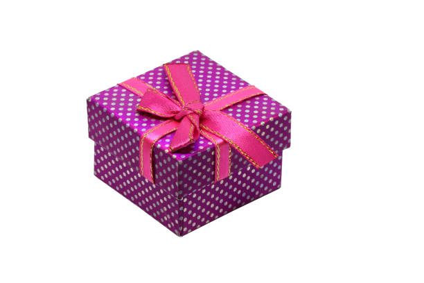 Purple gift box with white dots and red ribbon with bow, isolated on white background.