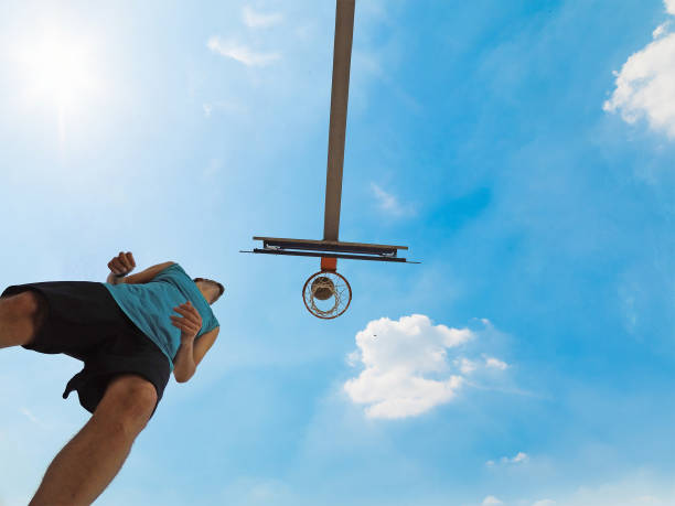 istock Basketball player by the hoop seen from below 1083059990