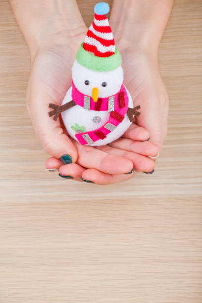 istock textile snowman woman hands wooden table studio 1083061318