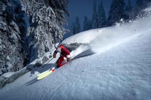 Santa goes skiing Santa skiing on powder slope lit with flash. ski resort flash stock pictures, royalty-free photos & images