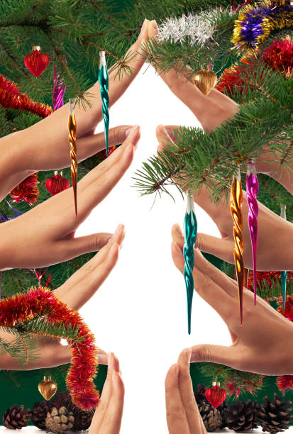 istock Christmas tree shape made by hands and framed with branches and ornaments 1083067682