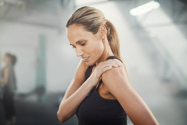 That really hurts Cropped shot of a sporty young woman suffering from a sport's injury shoulder stock pictures, royalty-free photos & images
