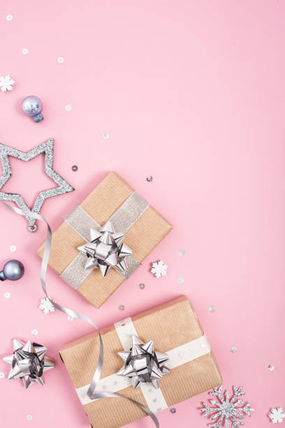 istock Christmas frame composition with silver decor and gifts on pastel pink background. Flat lay. Copy space. 1083070332