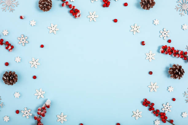 istock Christmas holiday background with copy space for text. View from the top. Decorative frame with holly berries and snowflakes. 1083070436