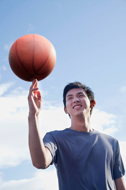 istock Chinese man balancing basketball on fingertip 1083072752