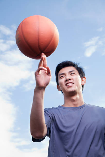 istock Chinese man balancing basketball on fingertip 1083072878