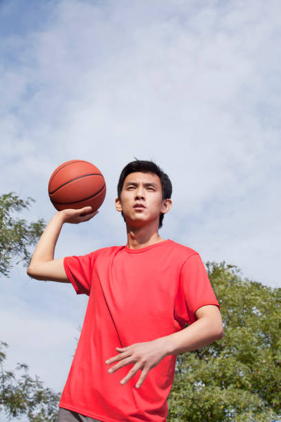 istock Chinese man playing basketball 1083072892