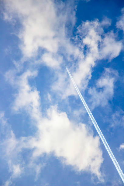 istock Skyscape with a plane and contrail through the clouds 1083080018