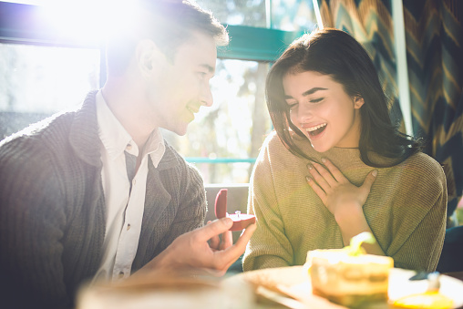 The happy man makes a proposal to his girlfriend in the restaurant