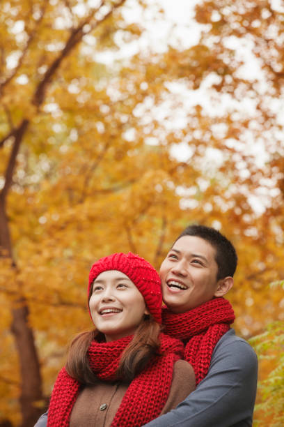 istock Young Chinese couple embracing in park 1083082072
