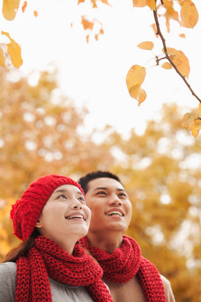 Chinese couple looking at autumn leaves