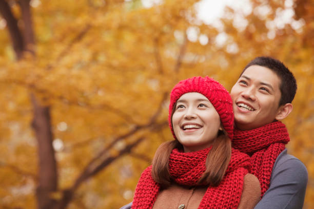 istock Young Chinese couple embracing in park 1083082338