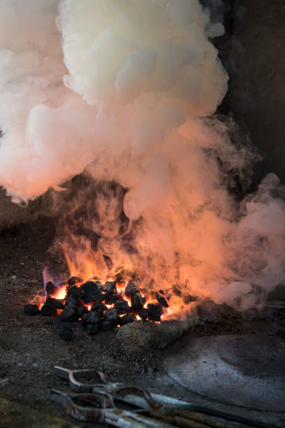 istock Traditional Turkish Tinsmith Covering the Copper Plate With Tin Over Fire 1083085696