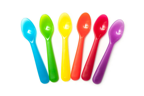 set of colorful baby plastic spoons on white background
