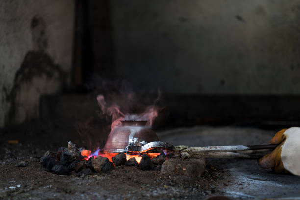 istock Traditional Turkish Tinsmith Covering the Copper Plate With Tin Over Fire 1083087994