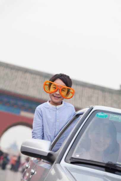 Chinese boy with large orange sunglasses