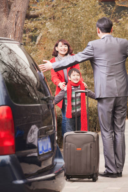 istock Chinese mother and son greeting returning father 1083089418