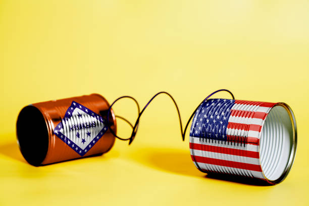 istock tin can phone with USA and Arkansas U.S. state Flags. communication concept 1083091342