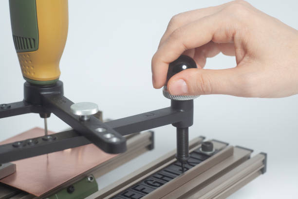istock Worker hands on Engraving device pantograph with CNC engraver with letterpress alphabet 1083091424