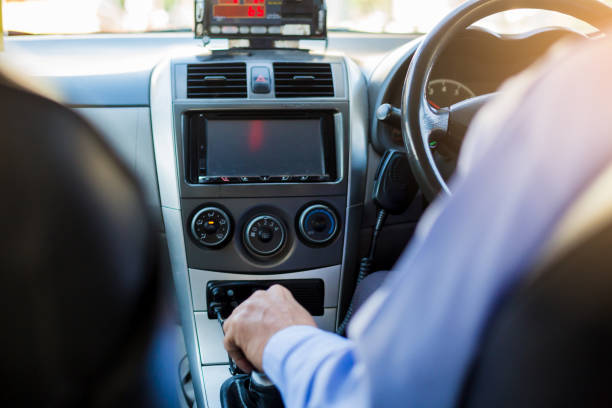 Selective focus of man driving and change gear a car