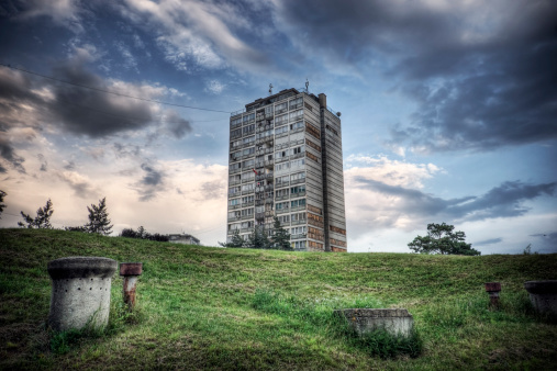 Run-down appartment building in southeast Europe set before a moody evening sky. \n\nAir vents for communist-era underground bunkers can be seen in the foreground. \n\nNeed a different layout?\n[url=file_closeup.php?id=10705487][img]file_thumbview_approve.php?size=1&id=10705487[/img][/url] \n\nPlease see my related collections...\n[url=search/lightbox/7431206][img]http://i161.photobucket.com/albums/t218/dave9296/Lightbox_Vetta.jpg[/img][/url]\n[url=search/lightbox/6315481][img]http://i161.photobucket.com/albums/t218/dave9296/Lightbox_HDR2-V2.jpg[/img][/url]
