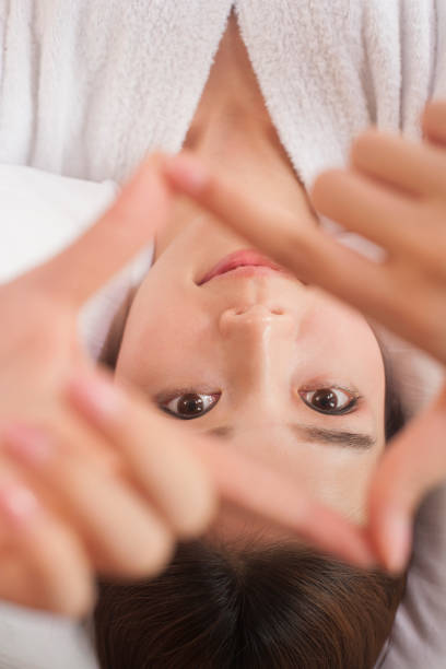 istock Chinese woman making shape with her fingers 1083098676