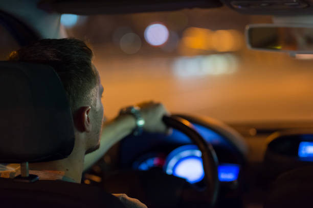 istock The man drive a car in the night city 1083100856