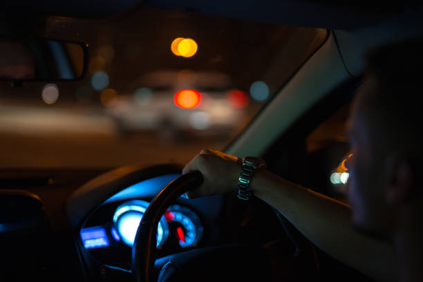 istock The man drive a car in the night time. Left side traffic 1083100908
