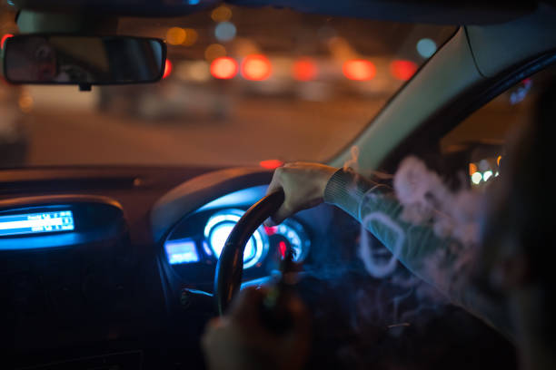 istock The man make a smoke rings in the car. Evening night time 1083100914