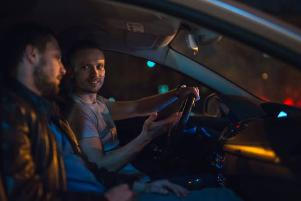 istock The men talk inside the car. Evening night time 1083100958