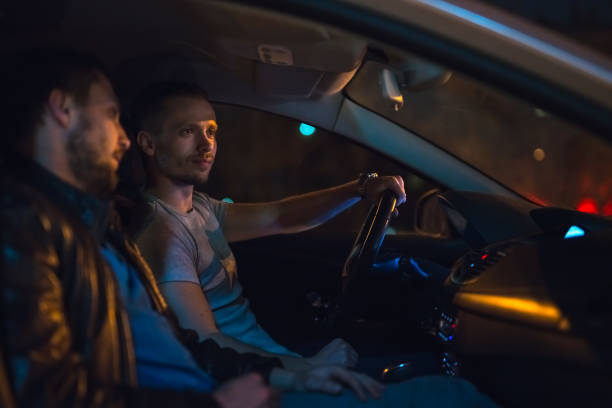 istock The men sit inside the car on the road. Evening night time 1083100966