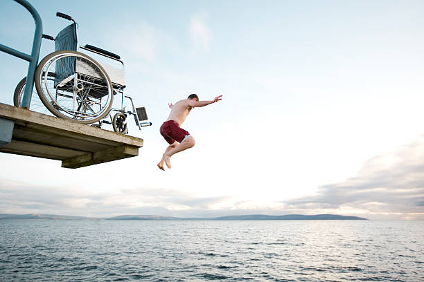 flying from wheelchair stock photo