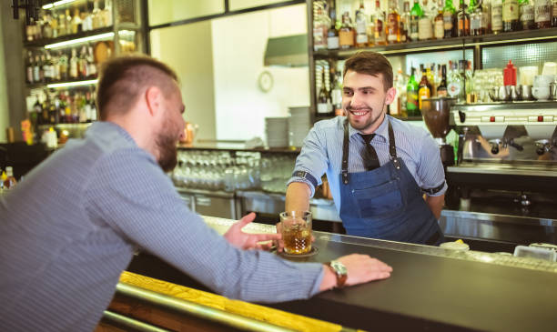 istock The happy barman talking with a visitor at the bar 1083103792