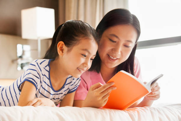 istock Chinese mother and daughter reading together 1083104050