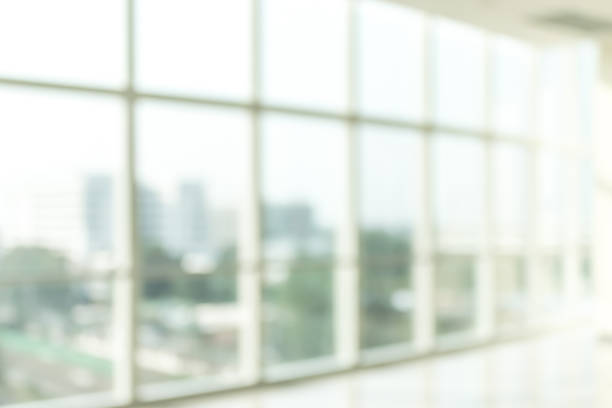 istock Blur background interior view looking out toward to empty office lobby and entrance doors and glass curtain wall 1083105736