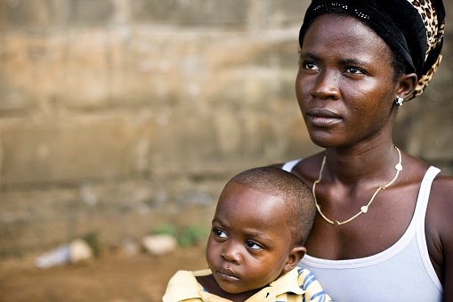 African mother holding her son.