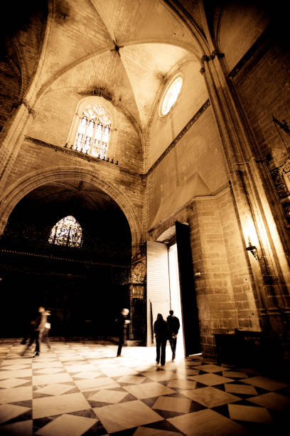The Door of Baptism showcases intricate Gothic architecture, highlighted by detailed carvings and the depiction of Jesus\