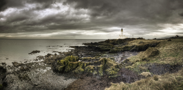 HDR Panorama of the lighthouse at Turnberry, Ayrshire, Scotland. It sits on the edge of the world famous Turnberry golf course. Heavy storm clouds add to the moody look of the image. Edited as a 16 bit ProPhoto Tiff in Lightroom and Color Efex Pro. Velvia conversion for impact. Some grain.