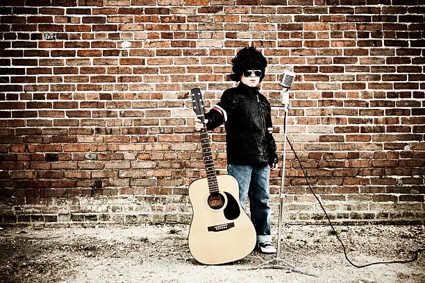A young boy dresses up as Elvis Presley to pay tribute. Just add type for the perfect rock and roll message.