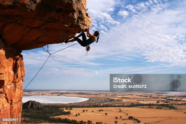 Young Woman Rock Climbing In The Desert Stock Photo - Download Image Now - Rock Climbing, Rock Overhang, Helmet