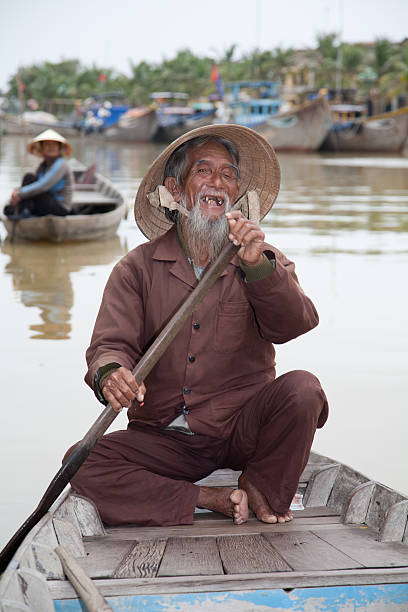 A serene boat floats on reflective waters connecting with a bamboo pier in the misty daylight