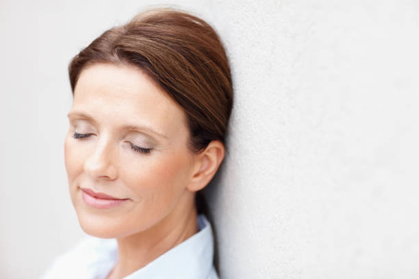 Mature woman with eyes closed