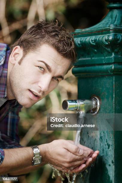 Молодой Человек Пить Из Фонтана Цветное Изображение — стоковые фотографии и другие картинки 25-29 лет