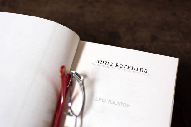 Open Book, Title Page: Anna Karenina, Leo Tolstoy Open Book, Title Page: Anna Karenina, Leo Tolstoy. Brown wood desk background with copy space. leo tolstoy stock pictures, royalty-free photos & images