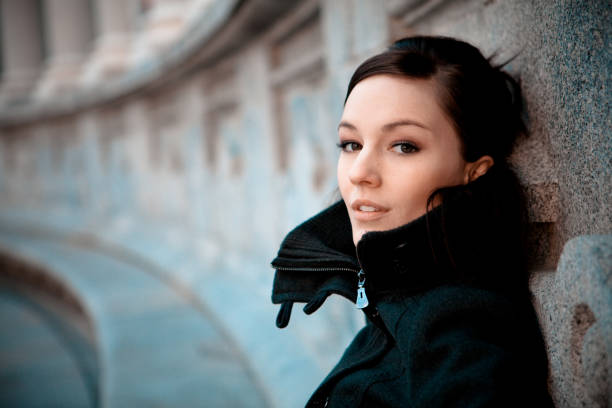 Urban portrait of a young woman in a black dress