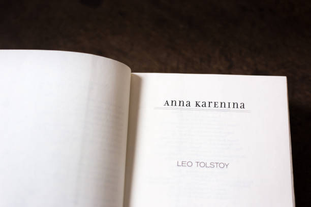Open Book, Title Page: Anna Karenina, Leo Tolstoy Open Book, Title Page: Anna Karenina, Leo Tolstoy. Brown wood desk background with copy space. leo tolstoy stock pictures, royalty-free photos & images