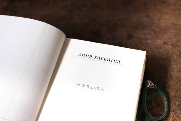 Open Book, Title Page: Anna Karenina, Leo Tolstoy Open Book, Title Page: Anna Karenina, Leo Tolstoy. Brown wood desk background with copy space. leo tolstoy stock pictures, royalty-free photos & images