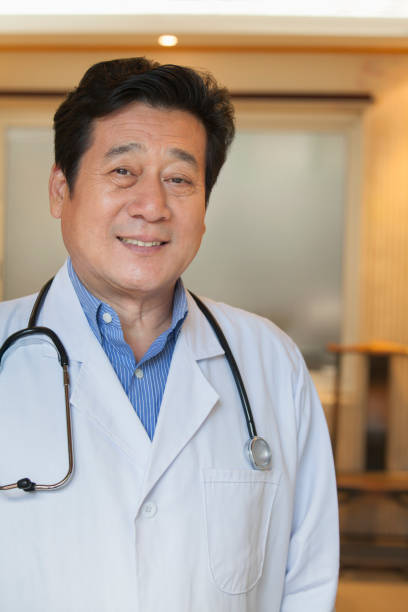 istock Chinese doctor smiling in office 1083115586