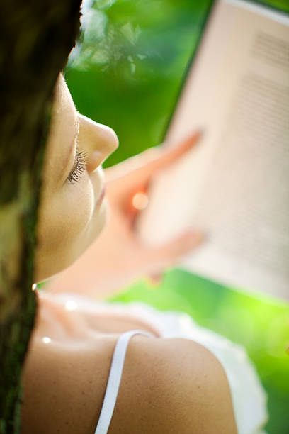 Young woman reading book stock photo